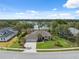 Beautiful aerial view of the home, showcasing its well-manicured lawn, three-car garage, and tranquil lake backdrop at 15615 Serengeti Blvd, Spring Hill, FL 34610