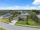 Aerial shot of a well-maintained home with mature landscaping, a spacious driveway, and a three car garage at 15615 Serengeti Blvd, Spring Hill, FL 34610