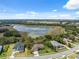 Aerial of homes in a lakeside neighborhood with mature trees, lush landscaping and blue sky at 15615 Serengeti Blvd, Spring Hill, FL 34610