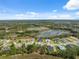 Breathtaking aerial view of the community, surrounded by lush greenery and tranquil lakes, showcasing the area's natural beauty at 15615 Serengeti Blvd, Spring Hill, FL 34610