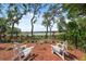 Inviting backyard with chairs overlooking a scenic lake, offering a serene and private outdoor retreat at 15615 Serengeti Blvd, Spring Hill, FL 34610