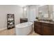 This luxurious bathroom features dual sinks, a soaking tub, and stylish decor at 15615 Serengeti Blvd, Spring Hill, FL 34610