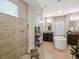 This stylish bathroom features dual sinks, a soaking tub, and a glass-enclosed shower at 15615 Serengeti Blvd, Spring Hill, FL 34610