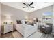 Cozy bedroom with a white bed, stylish decor, and lots of natural light at 15615 Serengeti Blvd, Spring Hill, FL 34610