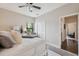 Bright bedroom featuring a ceiling fan, plush pillows, and a view through the window at 15615 Serengeti Blvd, Spring Hill, FL 34610