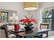 Staged dining room table with flowers beneath a modern pendant light fixture at 15615 Serengeti Blvd, Spring Hill, FL 34610