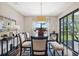 Dining room with lake view, slider to lanai, and modern furnishings at 15615 Serengeti Blvd, Spring Hill, FL 34610