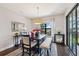 Dining area features dark wood table, modern pendant lighting, and sliding doors at 15615 Serengeti Blvd, Spring Hill, FL 34610