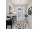 Inviting foyer with stylish decor, including a decorative mirror and a modern console table at 15615 Serengeti Blvd, Spring Hill, FL 34610