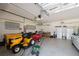 Spacious garage featuring painted floor, storage cabinets, and garage door with opener at 15615 Serengeti Blvd, Spring Hill, FL 34610