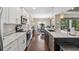Bright kitchen with stainless appliances, stone countertops, and open layout to the dining area at 15615 Serengeti Blvd, Spring Hill, FL 34610