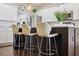 Kitchen island featuring barstool seating, pendant lighting, and hardwood floors at 15615 Serengeti Blvd, Spring Hill, FL 34610