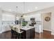 Bright kitchen featuring a large island with barstools, stainless appliances, and white cabinetry at 15615 Serengeti Blvd, Spring Hill, FL 34610