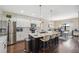 Modern kitchen with white cabinets, stainless appliances, granite counters, and eat-in island at 15615 Serengeti Blvd, Spring Hill, FL 34610
