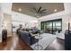 Open-concept living room boasts a sleek ceiling fan and sliding glass doors to screened patio at 15615 Serengeti Blvd, Spring Hill, FL 34610
