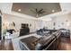 Expansive living room with black leather sectional and seamless flow into dining area at 15615 Serengeti Blvd, Spring Hill, FL 34610