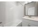 Bright bathroom features white subway tile surround, modern vanity, and a sleek, framed mirror at 206 S Tampania Ave # 4, Tampa, FL 33609