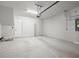 Spacious two car garage features speckled epoxy flooring, overhead lighting, and garage door opener at 206 S Tampania Ave # 4, Tampa, FL 33609