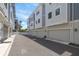 Exterior view of the garages with a paved driveway and the wall and facade of a gray townhome at 206 S Tampania Ave # 4, Tampa, FL 33609