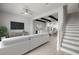 Bright living room with modern decor, neutral tones, ceiling fan, and staircase at 206 S Tampania Ave # 4, Tampa, FL 33609