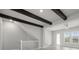 Living area with staircase, light wood floors and decorative beams at 206 S Tampania Ave # 4, Tampa, FL 33609