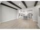 Open-concept living space with hardwood floors, white walls and dark beams at 206 S Tampania Ave # 4, Tampa, FL 33609