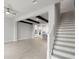 Spacious open floor plan featuring light wood floors, decorative beams, and view of the kitchen at 206 S Tampania Ave # 4, Tampa, FL 33609