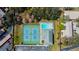 An aerial view that displays community tennis courts and sparkling swimming pool at 2547 Stony Brook Ln, Clearwater, FL 33761