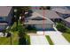 Aerial view of the home showcasing its location within the neighborhood, surrounded by mature trees at 2547 Stony Brook Ln, Clearwater, FL 33761