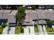 Aerial view of a home highlighting the layout of the house, garage, and driveway, surrounded by lush greenery at 2547 Stony Brook Ln, Clearwater, FL 33761