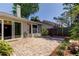 Paver patio in a private backyard with lush landscaping and fencing at 2547 Stony Brook Ln, Clearwater, FL 33761