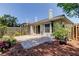 Paver patio in a fenced backyard with mature trees and landscaping at 2547 Stony Brook Ln, Clearwater, FL 33761