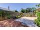 Fenced backyard with paver patio, bird bath, and lush landscaping at 2547 Stony Brook Ln, Clearwater, FL 33761