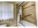 Bright bathroom featuring a tiled shower with glass doors and a convenient grab bar at 2547 Stony Brook Ln, Clearwater, FL 33761