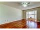 Bright bedroom features wood floors, a ceiling fan, and a sunny bay window at 2547 Stony Brook Ln, Clearwater, FL 33761