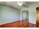 Bedroom features a ceiling fan, hardwood flooring, and a large mirrored closet at 2547 Stony Brook Ln, Clearwater, FL 33761