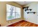 Bedroom features hardwood floors, a ceiling fan, a large window, and shelving unit at 2547 Stony Brook Ln, Clearwater, FL 33761