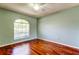 Bedroom features a ceiling fan, hardwood floors, and a large window at 2547 Stony Brook Ln, Clearwater, FL 33761