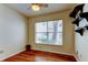 Cozy bedroom features hardwood floors, a ceiling fan, and a large window at 2547 Stony Brook Ln, Clearwater, FL 33761