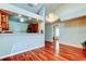 Bright dining room featuring hardwood floors, chandelier and view to second room at 2547 Stony Brook Ln, Clearwater, FL 33761
