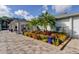 Beautiful property featuring a tiled walkway and mature landscaping with vibrant flowers and lush greenery at 2547 Stony Brook Ln, Clearwater, FL 33761