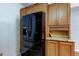 Kitchen boasts a modern, black refrigerator and warm wood cabinetry with granite countertops at 2547 Stony Brook Ln, Clearwater, FL 33761