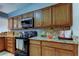 Updated kitchen features granite countertops, black appliances, and abundant wood cabinetry at 2547 Stony Brook Ln, Clearwater, FL 33761