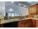 Kitchen area with wood cabinets and view to the living room at 2547 Stony Brook Ln, Clearwater, FL 33761