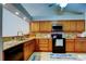 Functional kitchen with a deep sink and golden granite countertops and warm wood cabinetry at 2547 Stony Brook Ln, Clearwater, FL 33761