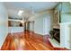 Open-concept living area with fireplace, hardwood floors and access to kitchen at 2547 Stony Brook Ln, Clearwater, FL 33761