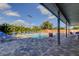 Outdoor pool with clear blue water and an expansive pool deck featuring tables and lounge chairs at 2547 Stony Brook Ln, Clearwater, FL 33761