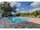 Outdoor pool with crystal clear water, set among palm trees and blue lounge chairs at 2547 Stony Brook Ln, Clearwater, FL 33761