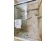 Modern tiled shower with a glass door, grab bar, and built-in niche at 2547 Stony Brook Ln, Clearwater, FL 33761