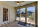 Enclosed sunroom with tiled floor, leading to a fenced backyard at 2547 Stony Brook Ln, Clearwater, FL 33761